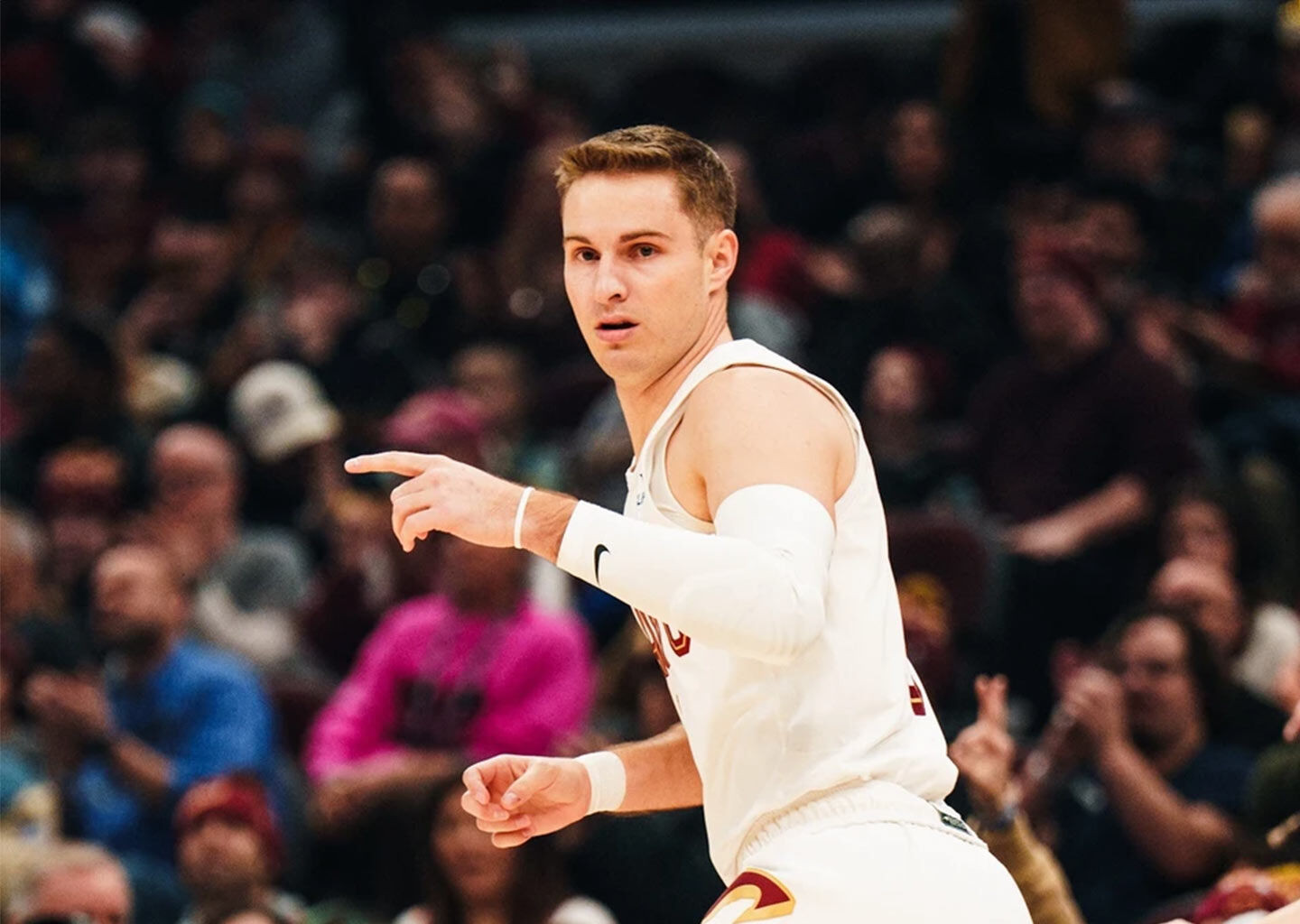 Sam Merrill running down the court, pointing